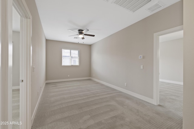 spare room featuring ceiling fan and light carpet