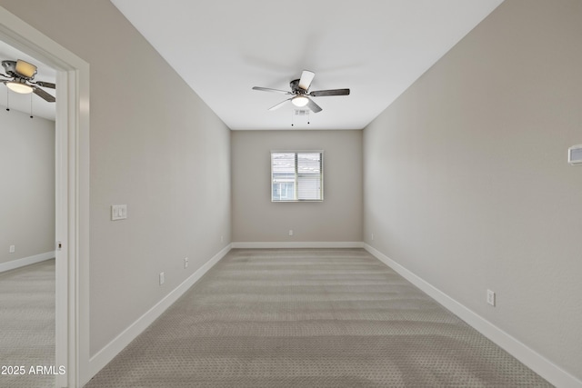 spare room featuring light carpet and ceiling fan