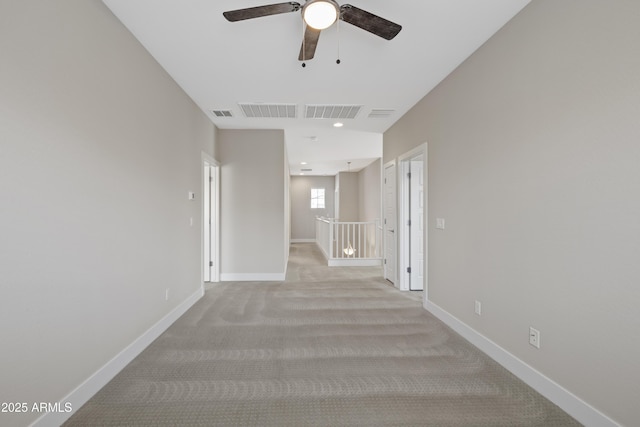 hallway featuring light colored carpet