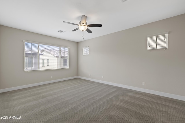 carpeted spare room with ceiling fan