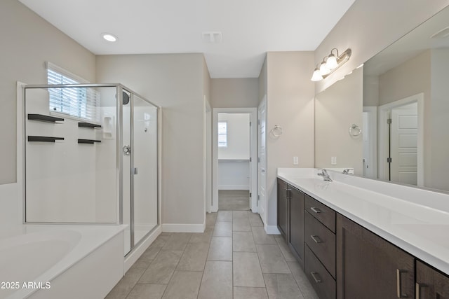 bathroom featuring vanity, plus walk in shower, and tile patterned flooring