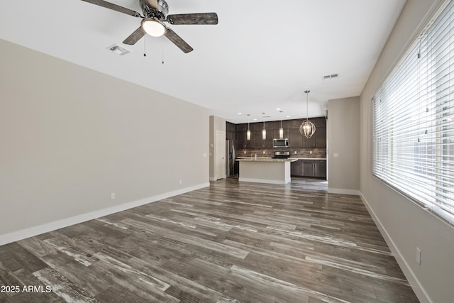 unfurnished living room with ceiling fan and dark hardwood / wood-style flooring