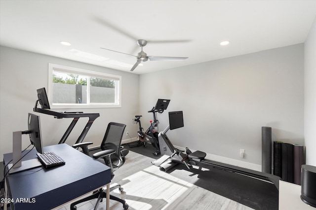 exercise room with hardwood / wood-style floors and ceiling fan