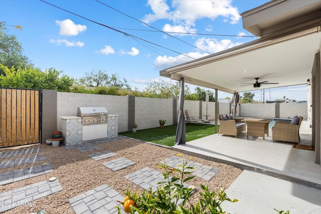 view of patio / terrace featuring exterior kitchen, ceiling fan, an outdoor hangout area, and grilling area