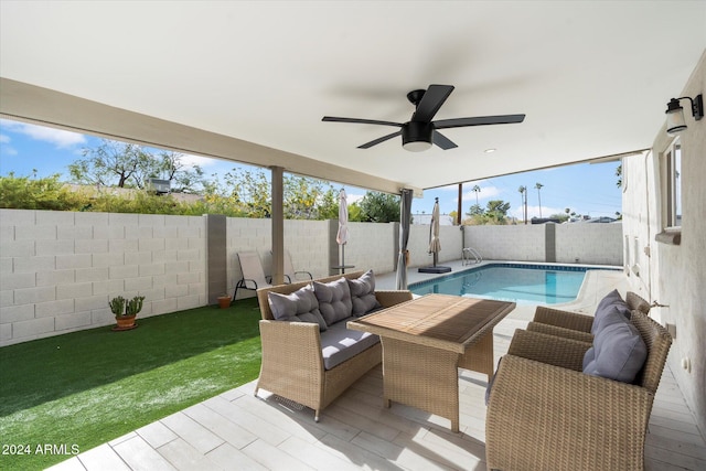 view of pool featuring a patio, outdoor lounge area, and ceiling fan