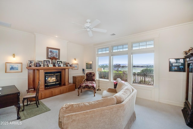 19125 N Lower Territory Rd, Prescott, AZ 86305 - living area with a glass covered fireplace, carpet floors, crown molding, ceiling fan, and healthy amount of natural light