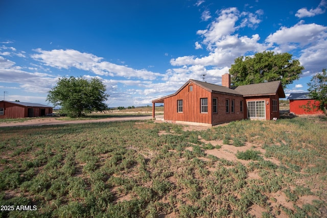 19125 N Lower Territory Rd, Prescott, AZ 86305 - view of home's exterior with a chimney and board and batten siding