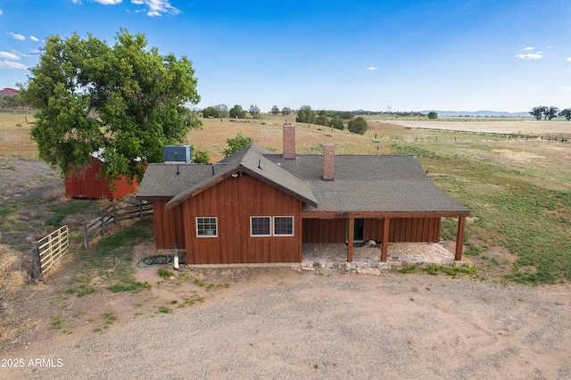 19125 N Lower Territory Rd, Prescott, AZ 86305 - view of front of home with a chimney, a view of countryside, a shingled roof, and board and batten siding
