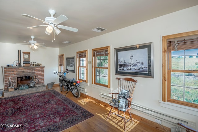 19125 N Lower Territory Rd, Prescott, AZ 86305 - living room with wood finished floors, plenty of natural light, a baseboard radiator, and a brick fireplace