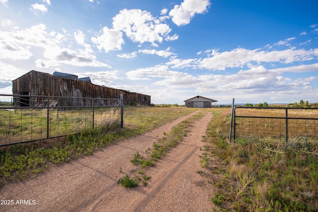 19125 N Lower Territory Rd, Prescott, AZ 86305 - view of dirt / gravel road featuring a view of countryside, a pole building, and a gated entry