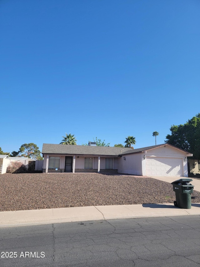 ranch-style home with an attached garage and concrete driveway