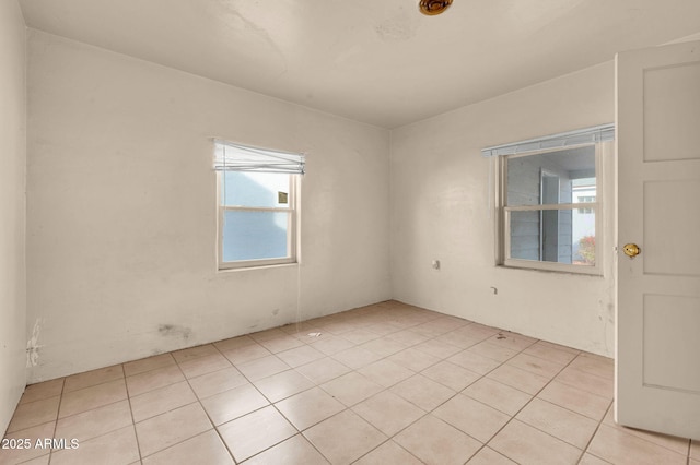 spare room with light tile patterned floors