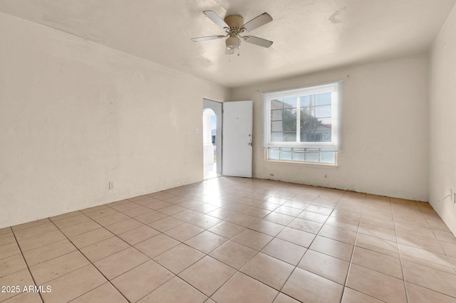 spare room with ceiling fan and light tile patterned floors