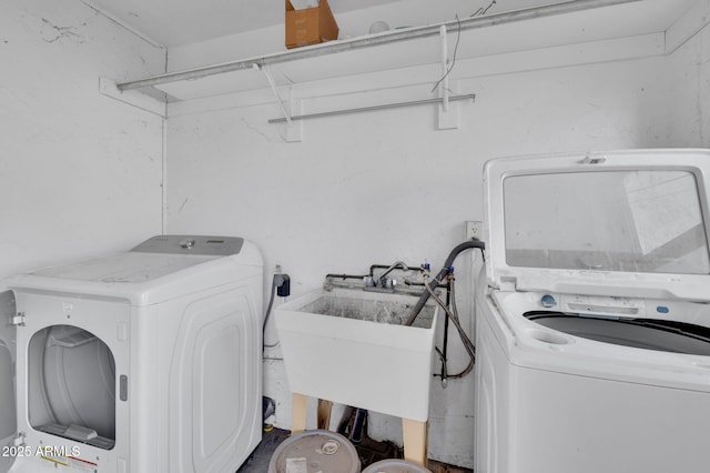 laundry room featuring sink and washing machine and clothes dryer