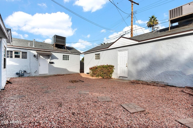 rear view of house with central AC