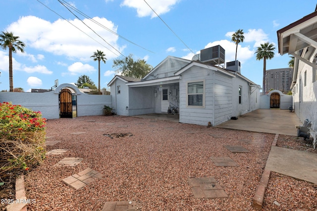 rear view of house with central AC