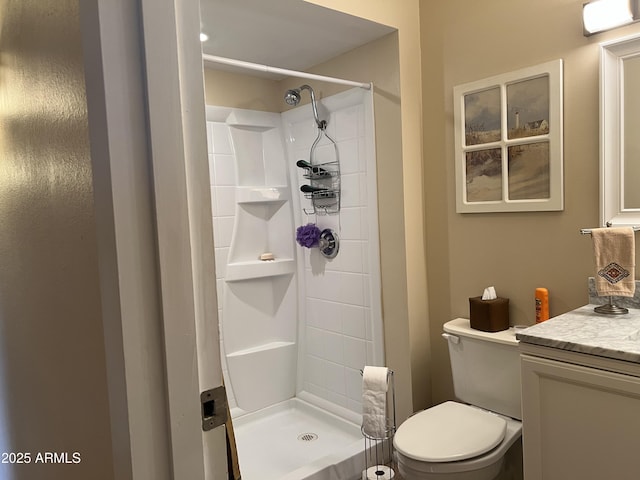 bathroom featuring vanity, toilet, and walk in shower