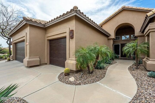 14058 S 24th Way, Phoenix, AZ 85048 - view of side of property with stucco siding, a garage, and a tiled roof