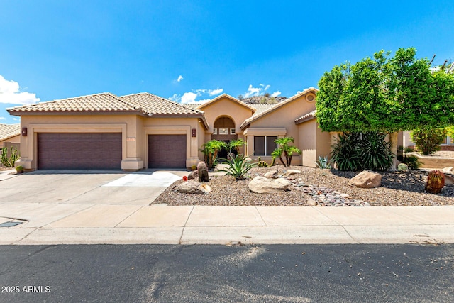 14058 S 24th Way, Phoenix, AZ 85048 - mediterranean / spanish house featuring an attached garage, driveway, stucco siding, and a tile roof