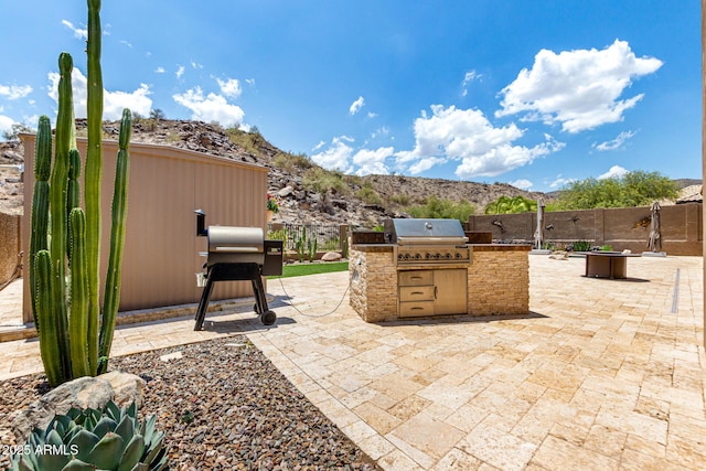 14058 S 24th Way, Phoenix, AZ 85048 - view of patio / terrace with exterior kitchen and a mountain view