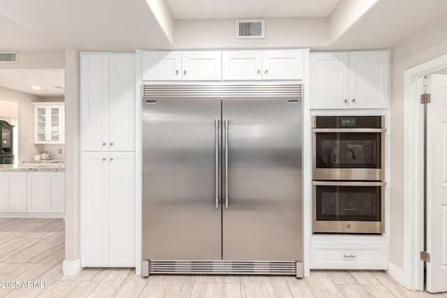 14058 S 24th Way, Phoenix, AZ 85048 - kitchen with appliances with stainless steel finishes and white cabinetry