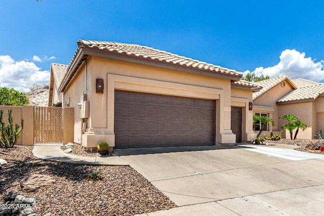 14058 S 24th Way, Phoenix, AZ 85048 - view of front of house featuring an attached garage, driveway, a tile roof, and stucco siding