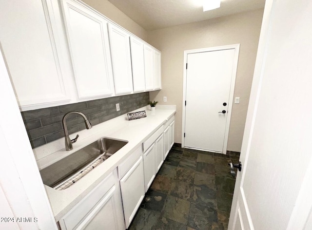 kitchen with sink, decorative backsplash, and white cabinetry