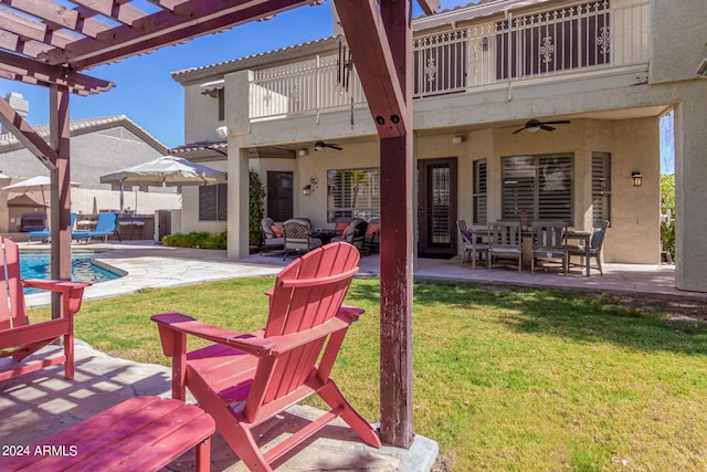 view of yard with a balcony, a patio, and ceiling fan