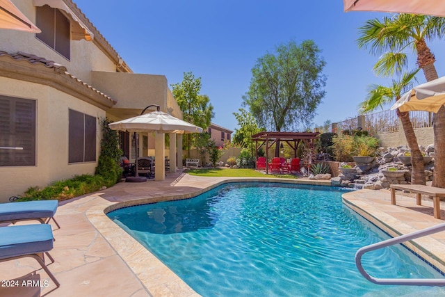 view of swimming pool featuring a patio and a gazebo