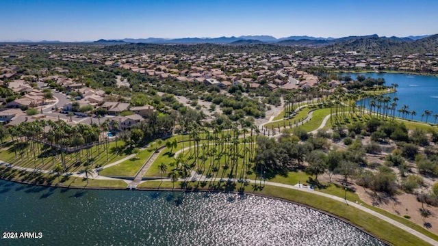 drone / aerial view featuring a water and mountain view