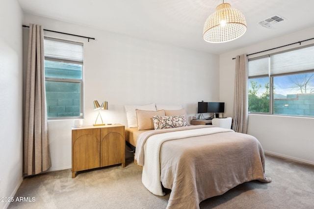 bedroom with visible vents, baseboards, and light colored carpet