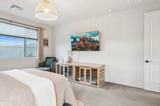 carpeted bedroom featuring visible vents