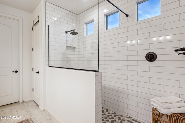 bathroom featuring walk in shower and wood finished floors