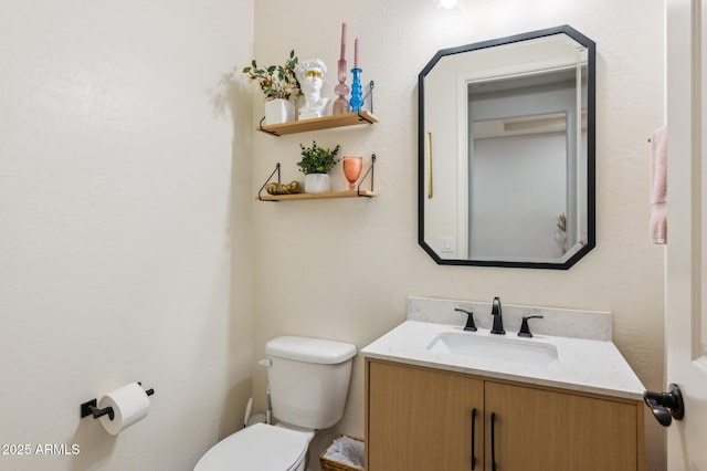 half bathroom with toilet and vanity