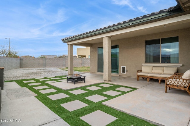 exterior space with a patio area, a fenced backyard, and an outdoor fire pit