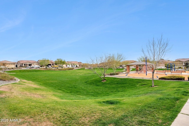 view of community featuring a gazebo, a lawn, and a residential view