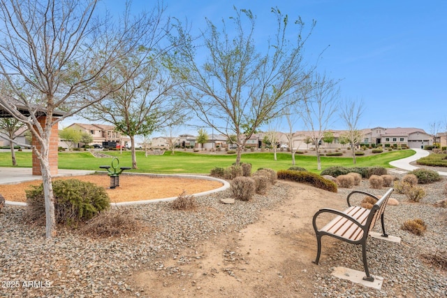 view of community featuring a residential view and a yard