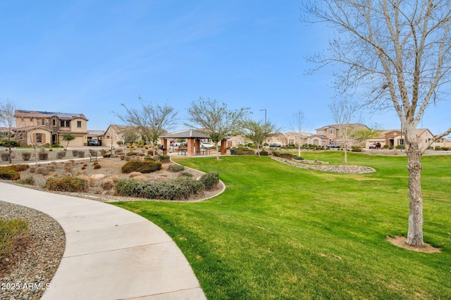 view of home's community featuring a gazebo, a lawn, and a residential view