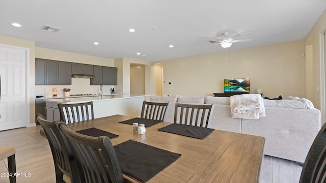 dining area featuring light hardwood / wood-style flooring and ceiling fan