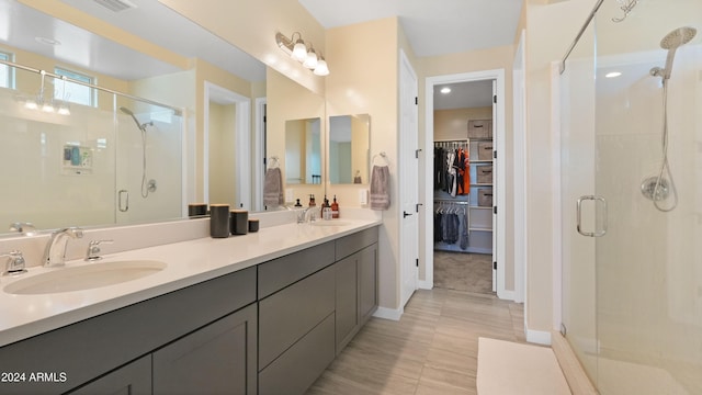 bathroom with vanity and a shower with shower door