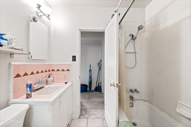 full bathroom with vanity, tile patterned flooring, tiled shower / bath combo, decorative backsplash, and toilet