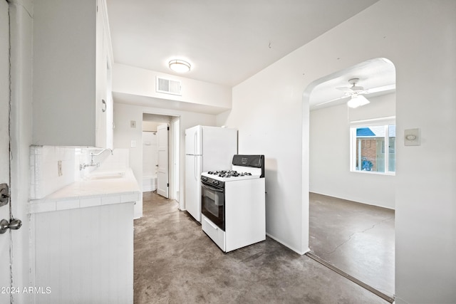 kitchen featuring ceiling fan, sink, white cabinets, and white appliances