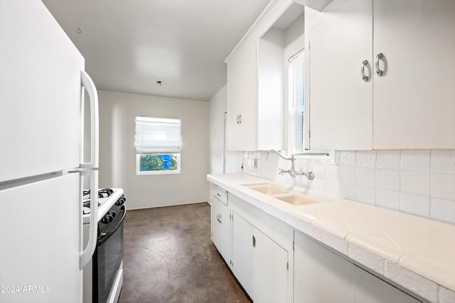 kitchen featuring sink, tile countertops, white appliances, decorative backsplash, and white cabinets