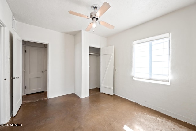 unfurnished bedroom with a textured ceiling, a closet, and ceiling fan