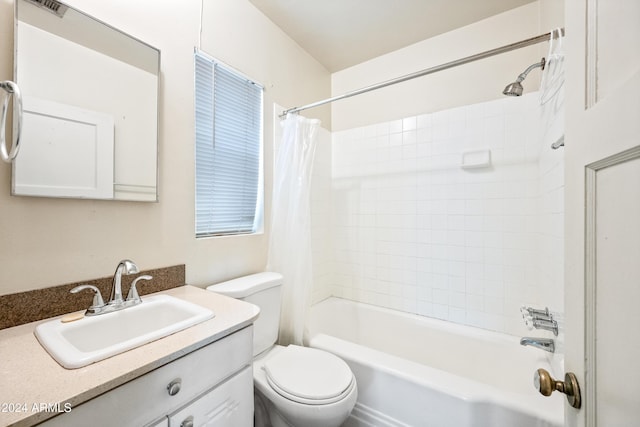 full bathroom featuring shower / bath combo, vanity, and toilet