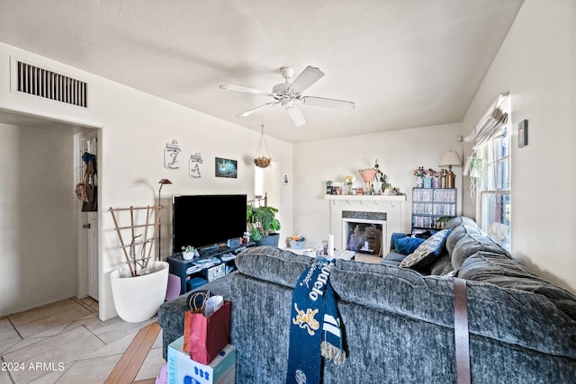 tiled living room with ceiling fan