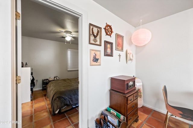 bedroom with dark tile patterned flooring and ceiling fan