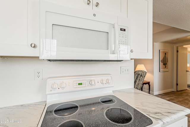 4554 E Paradise Village Pkwy N Unit 249, Phoenix, AZ 85032 - interior details with white appliances, white cabinetry, and baseboards