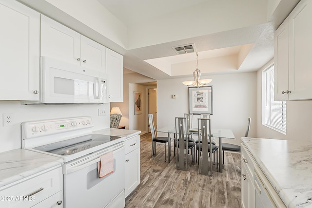 4554 E Paradise Village Pkwy N Unit 249, Phoenix, AZ 85032 - kitchen featuring white cabinetry, a tray ceiling, white appliances, visible vents, and light wood-style flooring