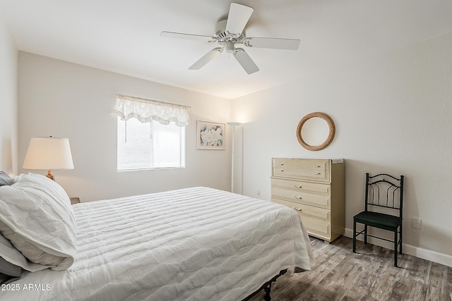 4554 E Paradise Village Pkwy N Unit 249, Phoenix, AZ 85032 - bedroom featuring baseboards, wood finished floors, and a ceiling fan